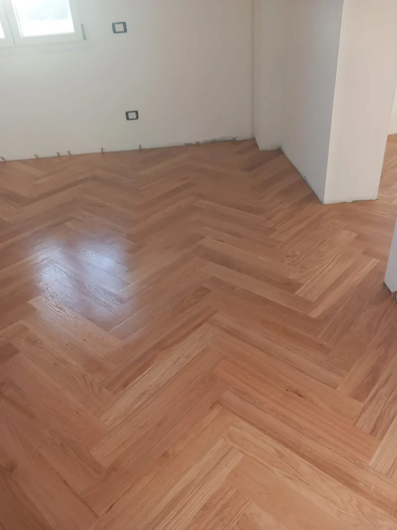 Stanza con parquet prefinito in rovere a spina di pesce